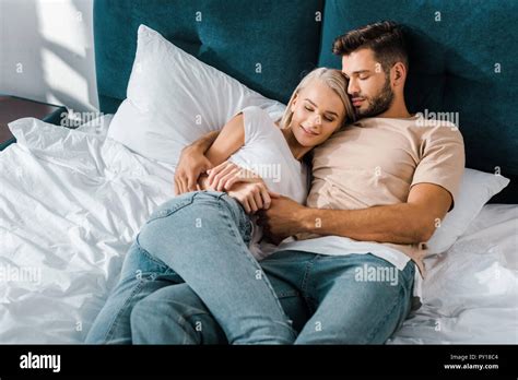 couple hugging bed|Smiling Young Couple Hugging and Kissing in Bed .